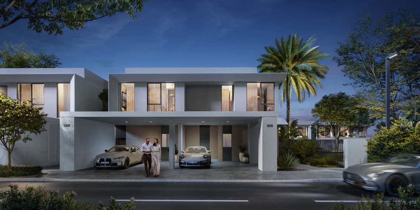 Alva at The Valley by Emaar — townhouse facades at dusk with covered parking and landscaped street